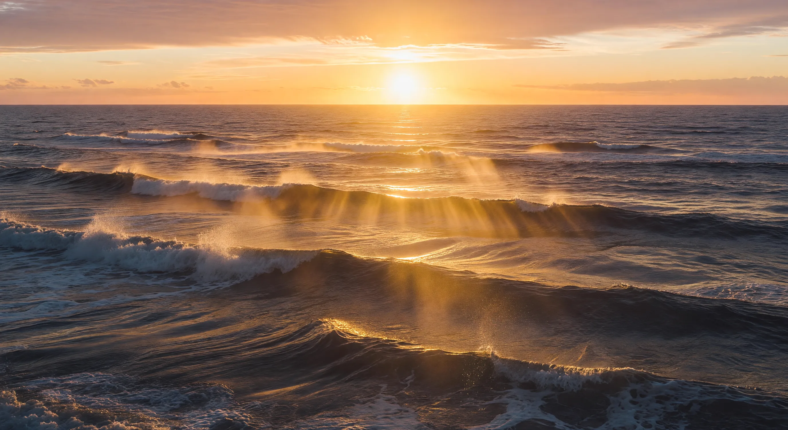 Sunrise over ocean waves